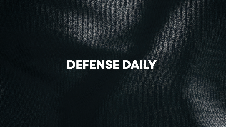 Black and white textured background with the Defense Daily wordmark logo in white centered.